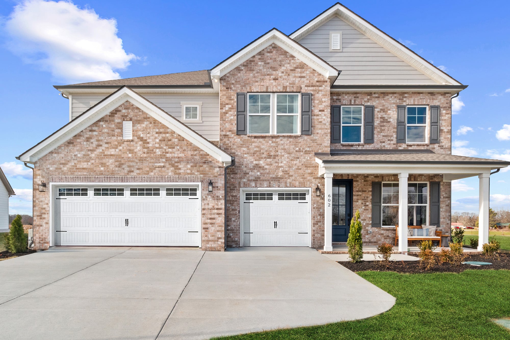 A brick house with a garage.