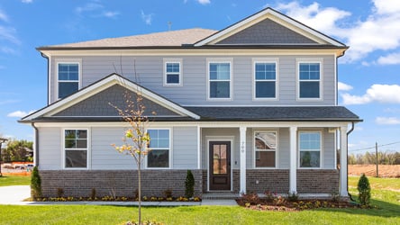 A house with a tree in the front.