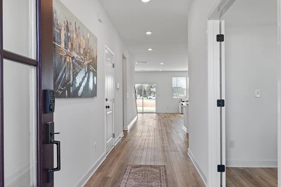 A hallway with white walls.