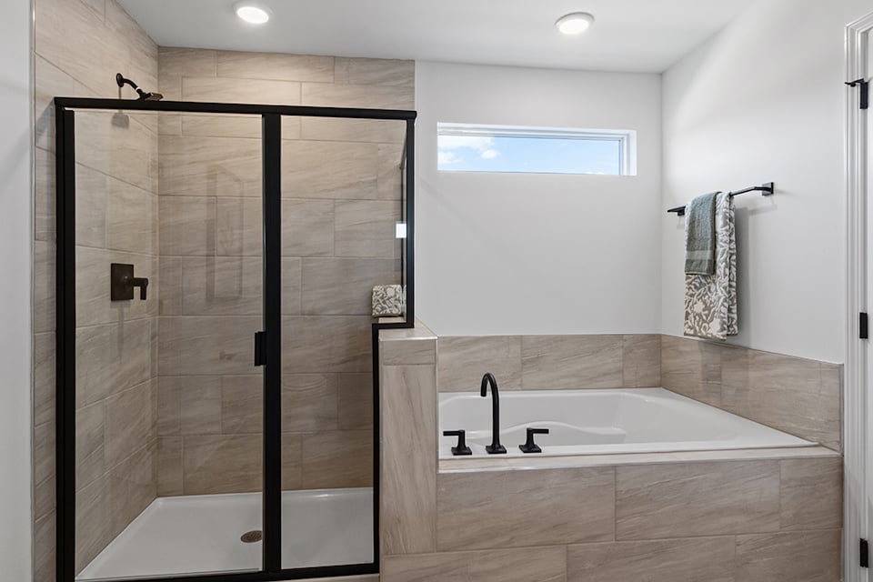 A bathroom with a bathtub and shower.