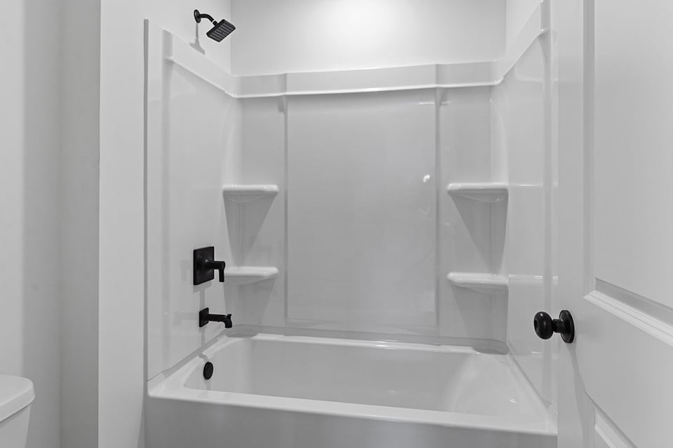 A bathtub with a glass door.