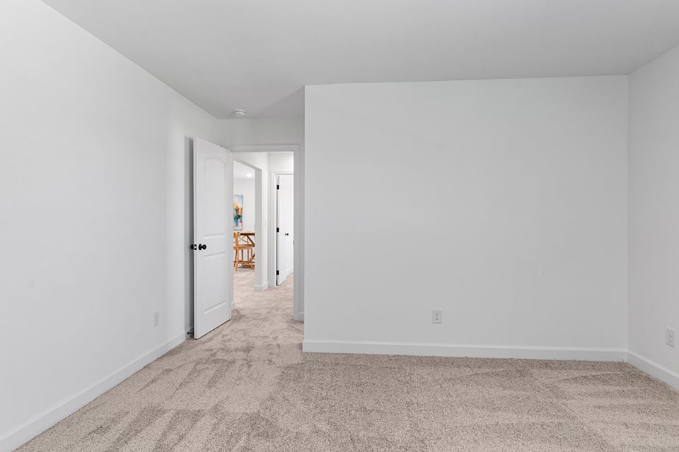 A hallway with white walls.