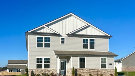 A white house with a grass yard.
