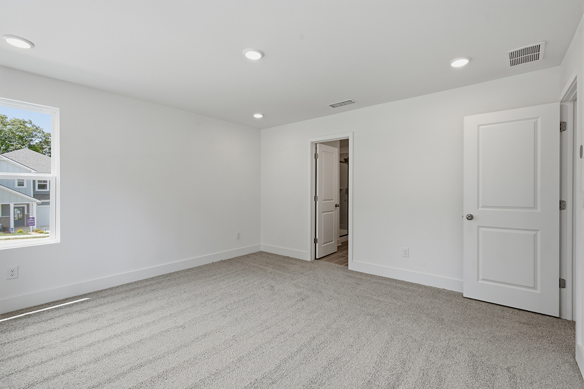A room with white walls and a window.