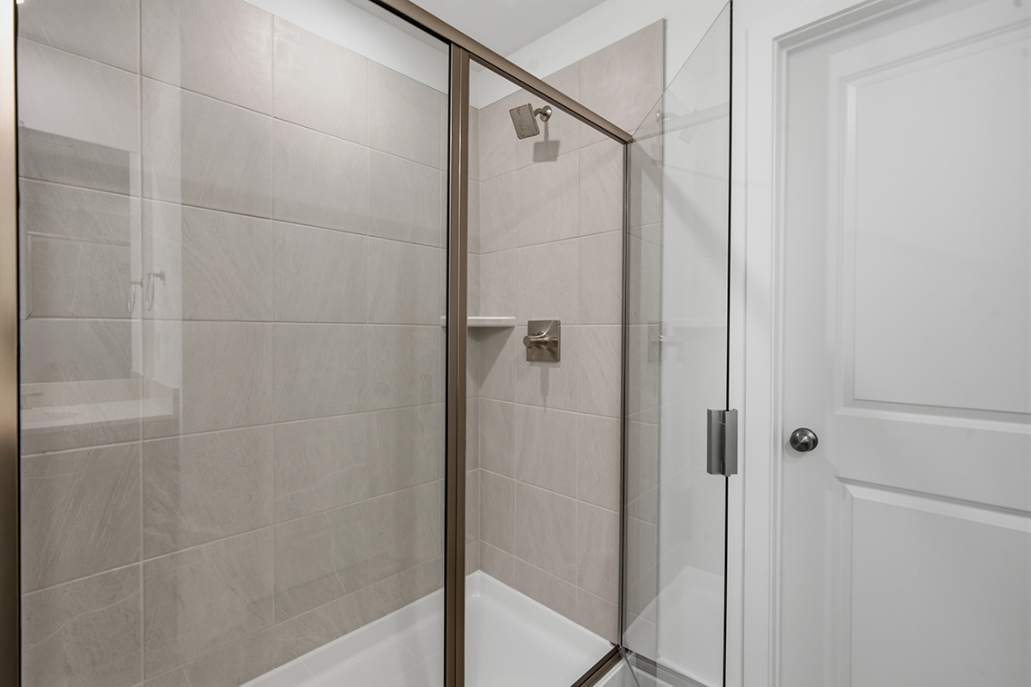 A shower with a glass door.