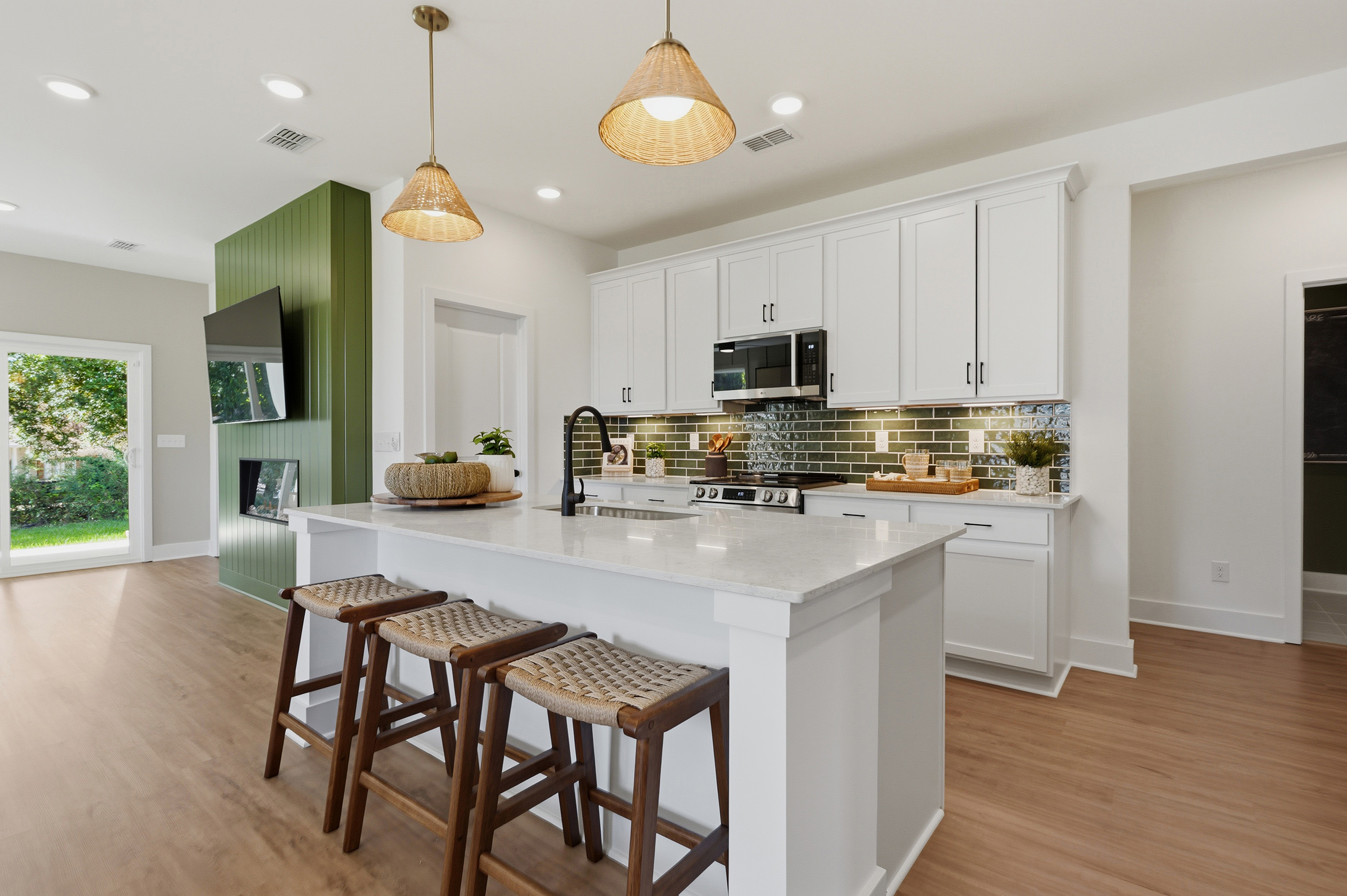 A kitchen with white cabinets.