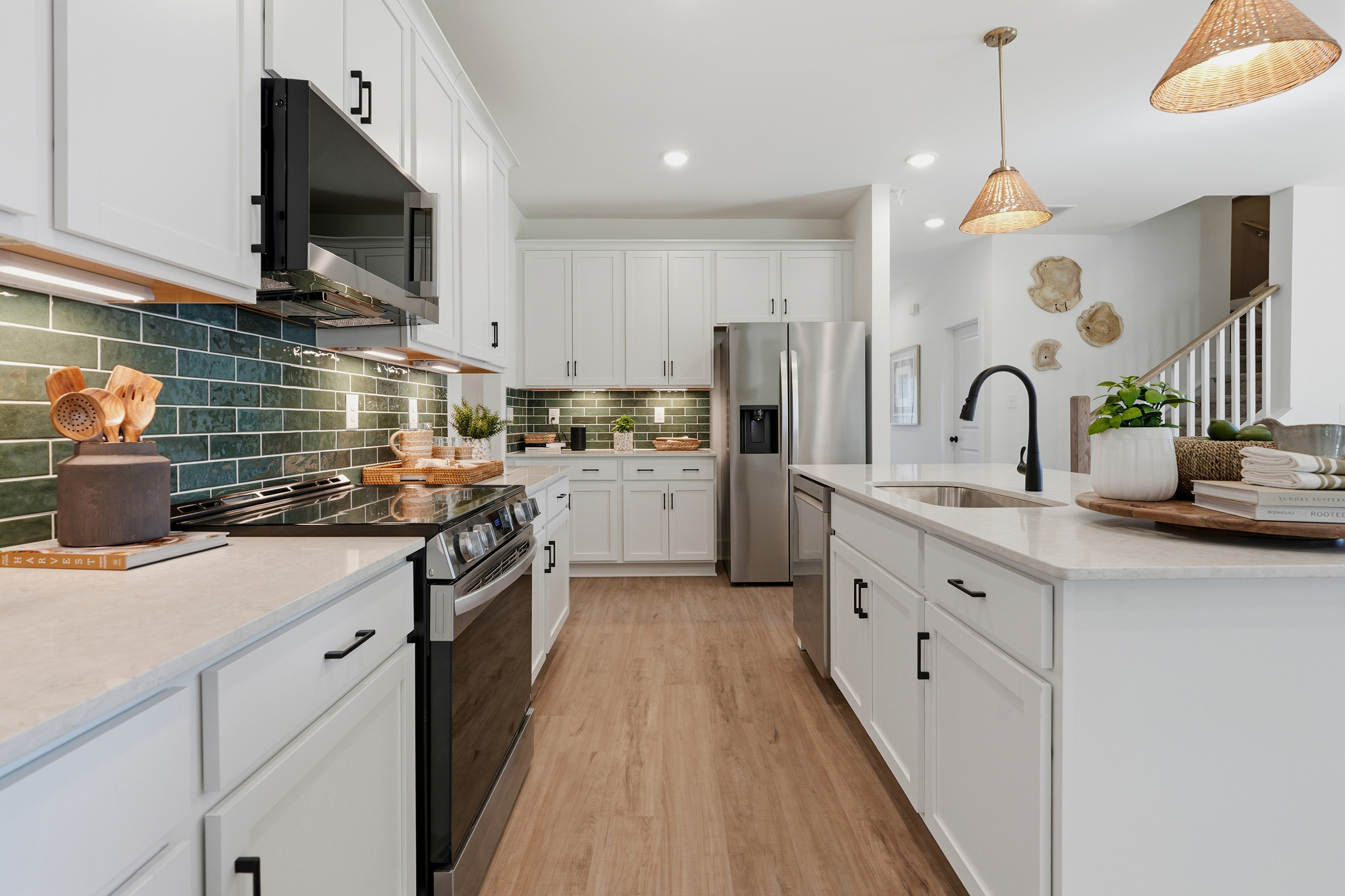 A kitchen with white cabinets.