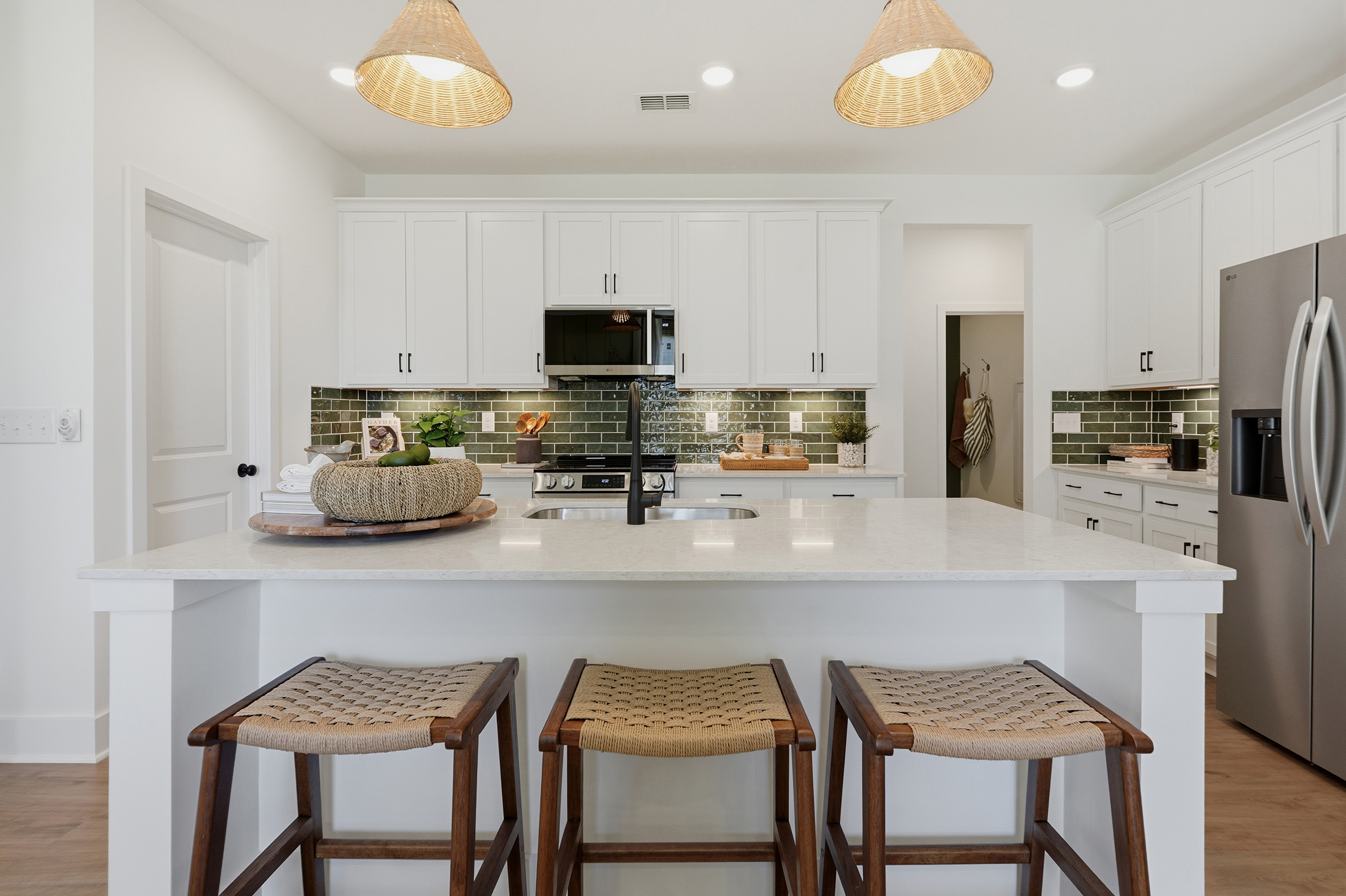 A kitchen with white cabinets.