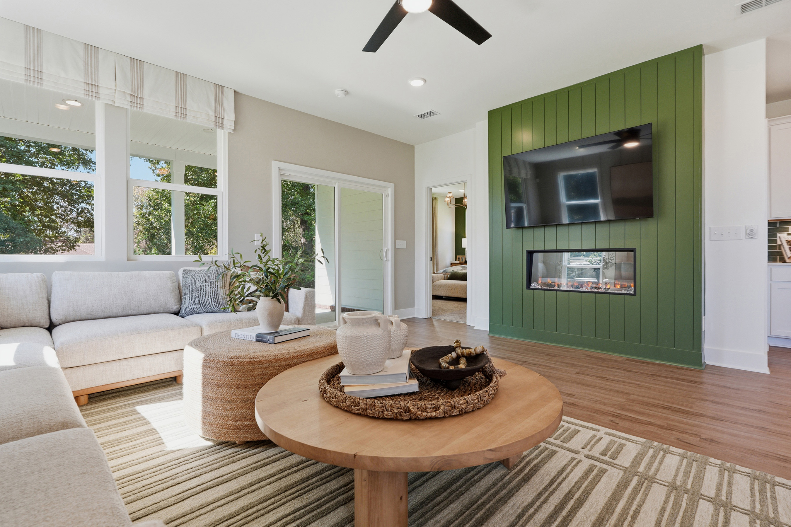 A living room with a green wall.