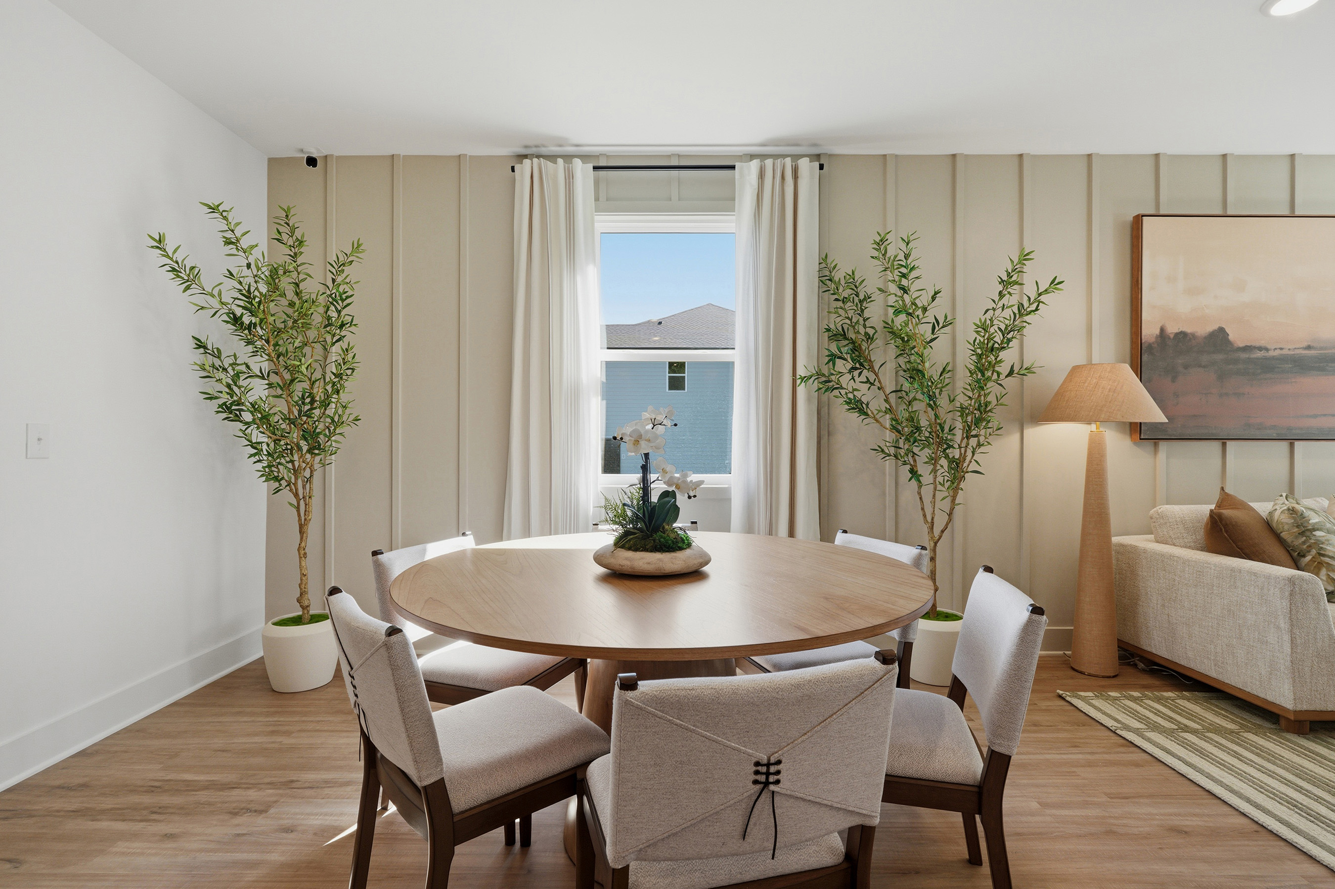 A dining room with a large window.
