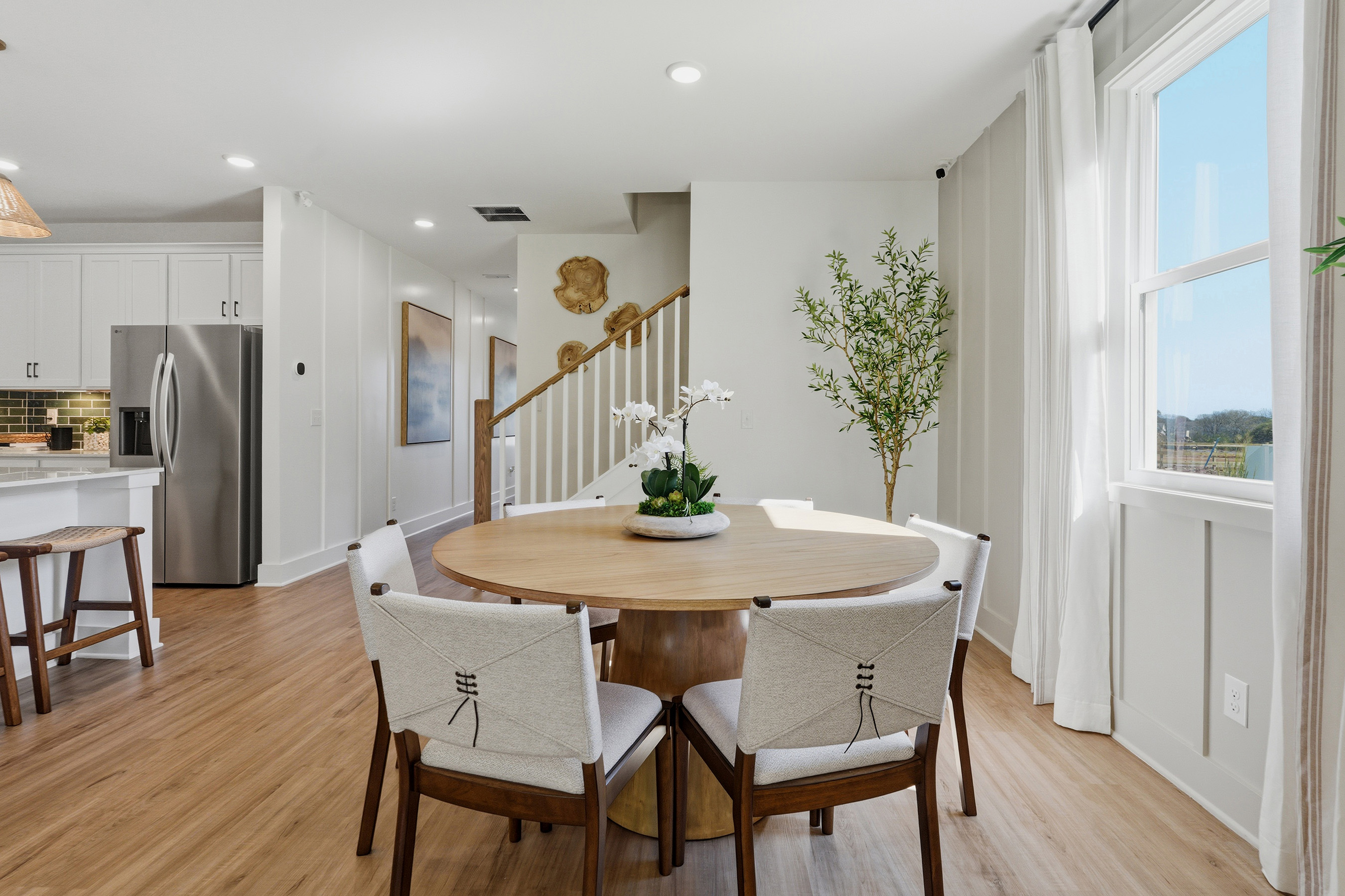 A dining room with a table and chairs.