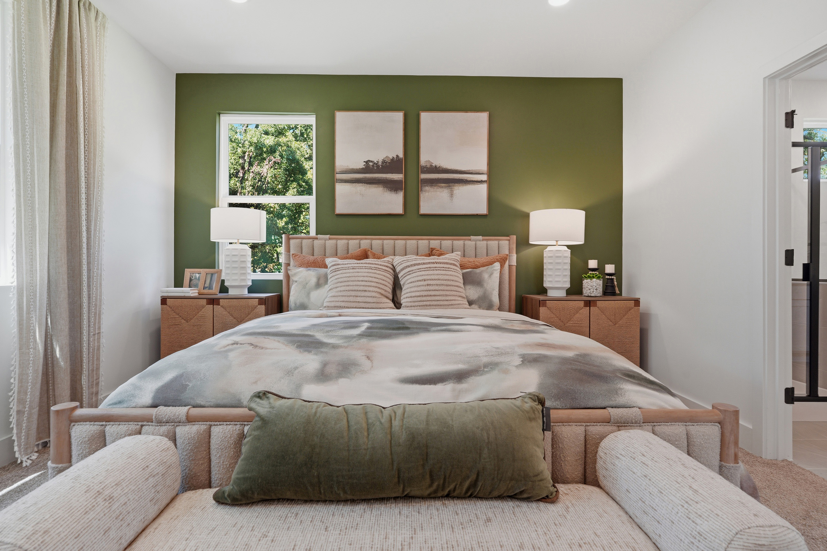 A bed with a green wall.
