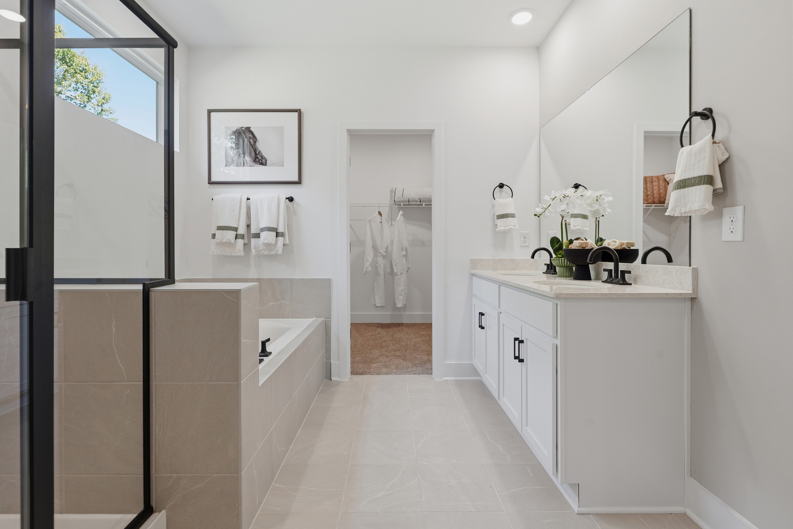 A bathroom with a sink and a shower unit.
