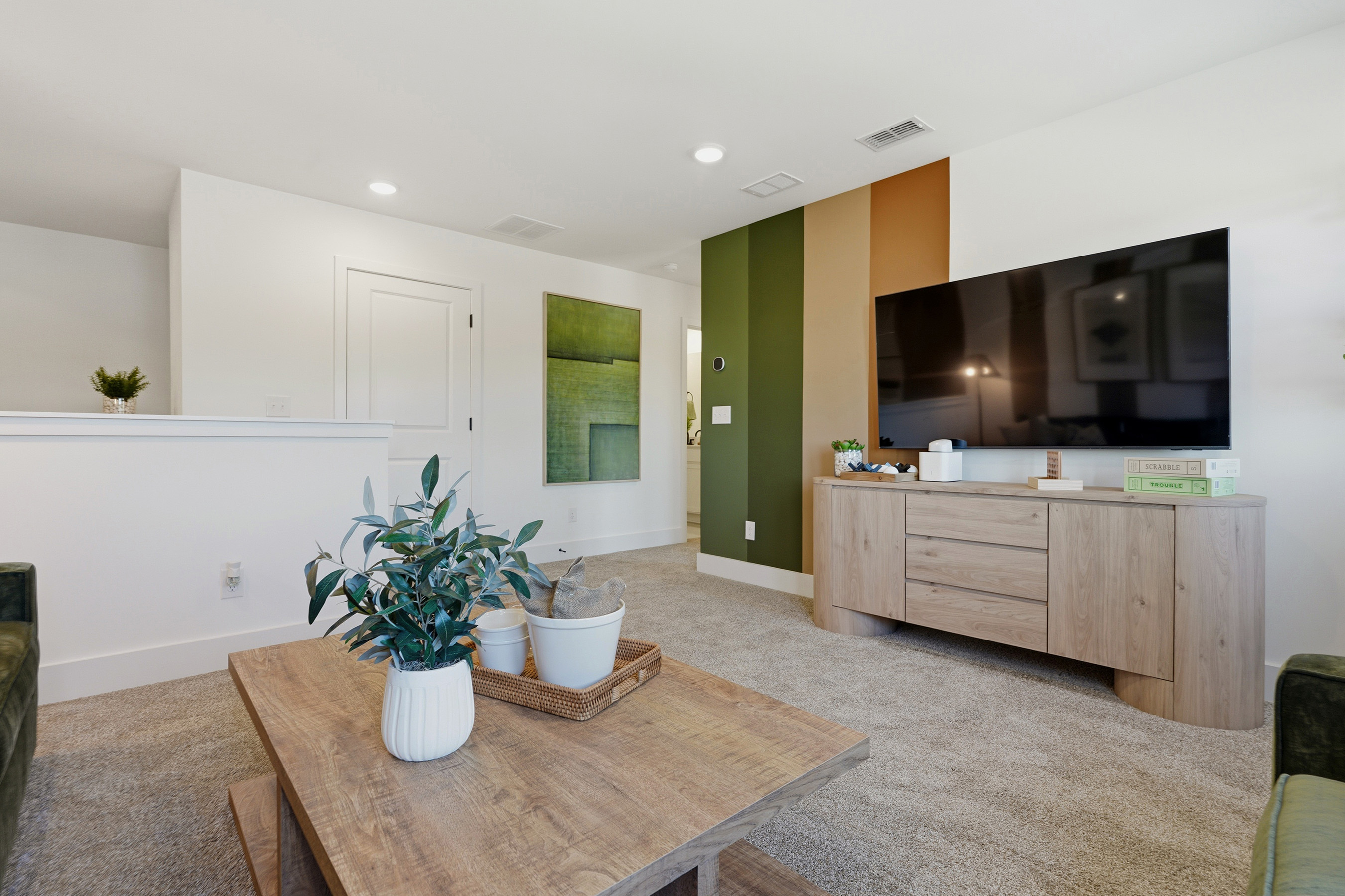 A kitchen with a table and plants.