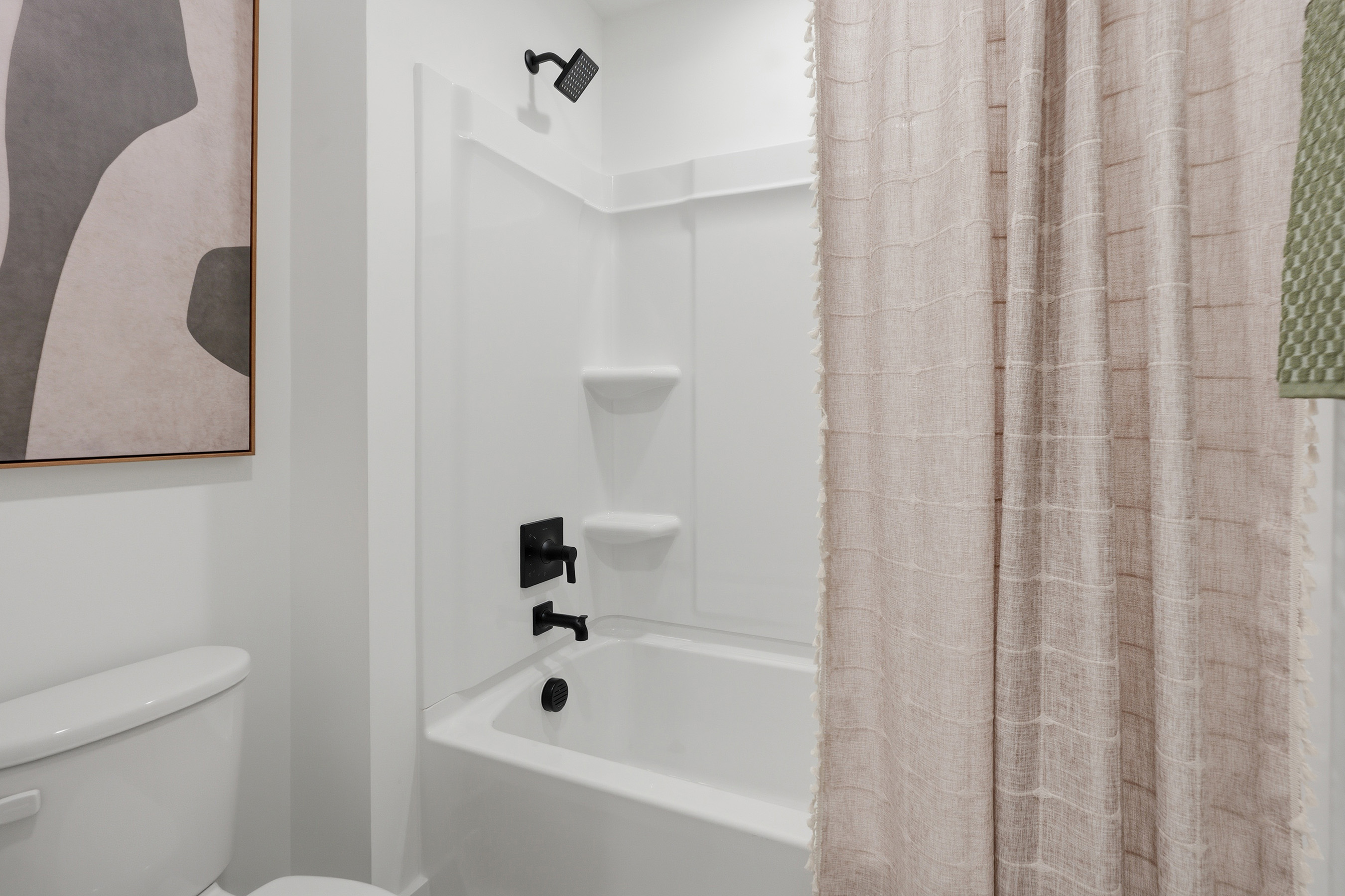 A bathroom with a tub toilet and sink.