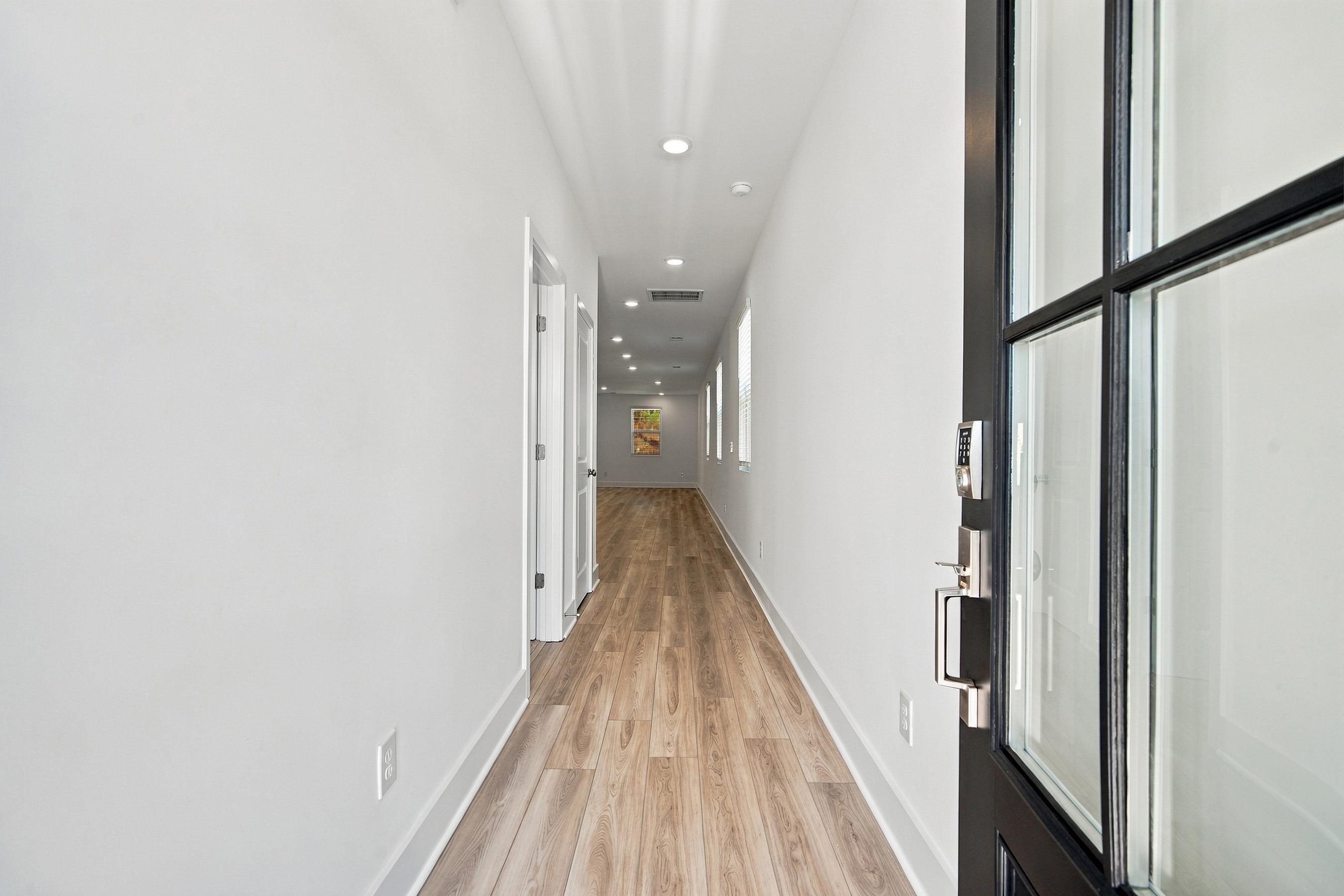 A hallway with white walls.