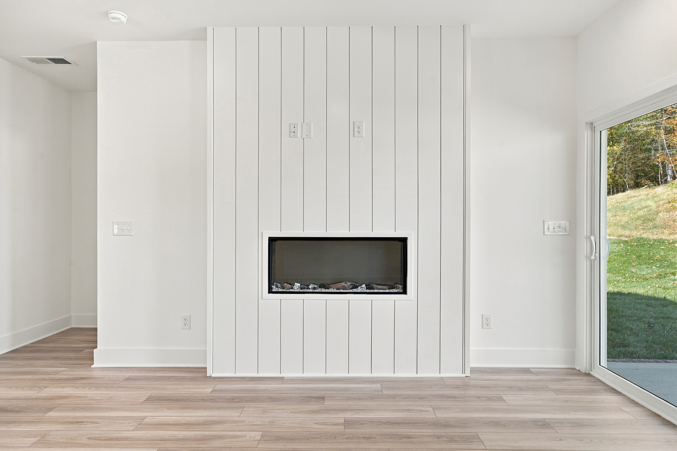 A white room with a tv and a white wall.
