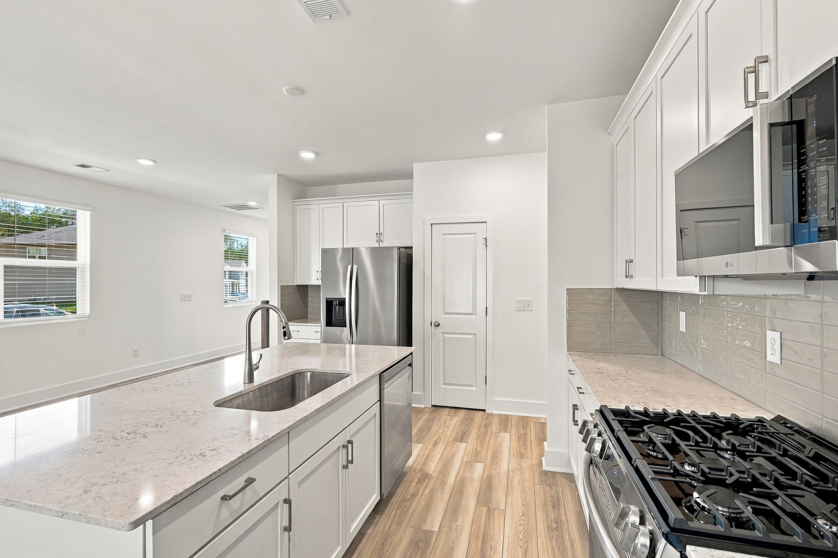 A kitchen with white cabinets.