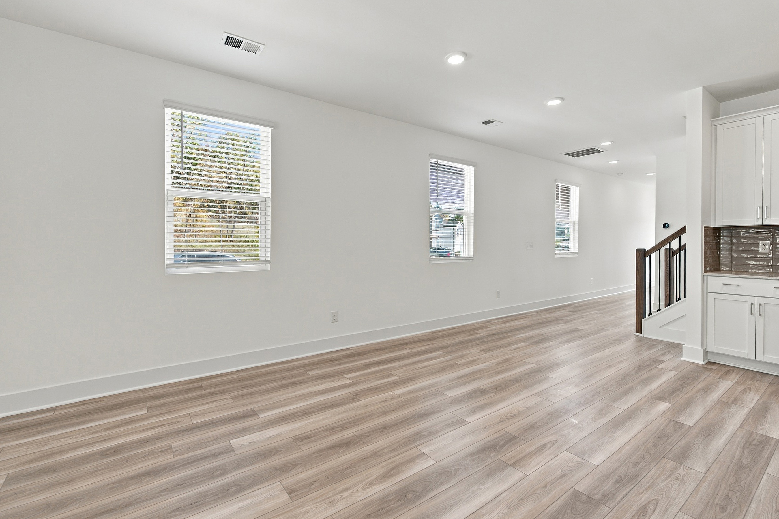 A room with a wood floor and white walls.