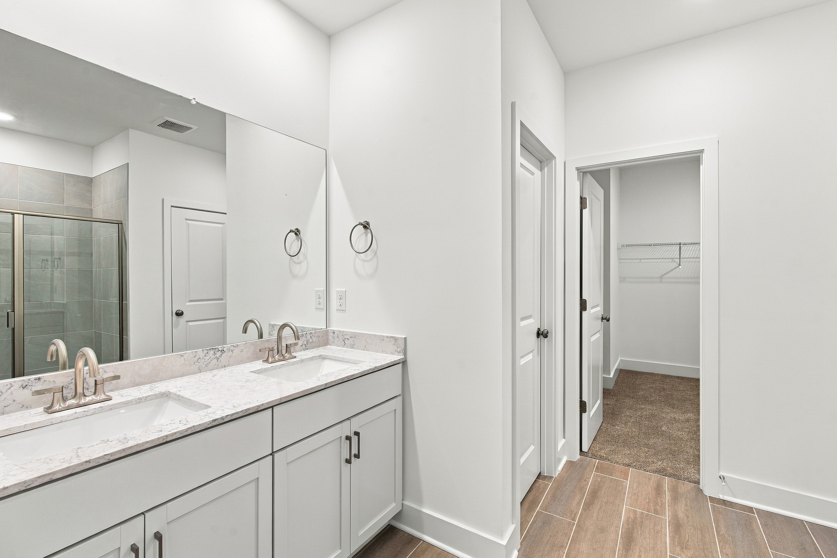 A bathroom with a large mirror.