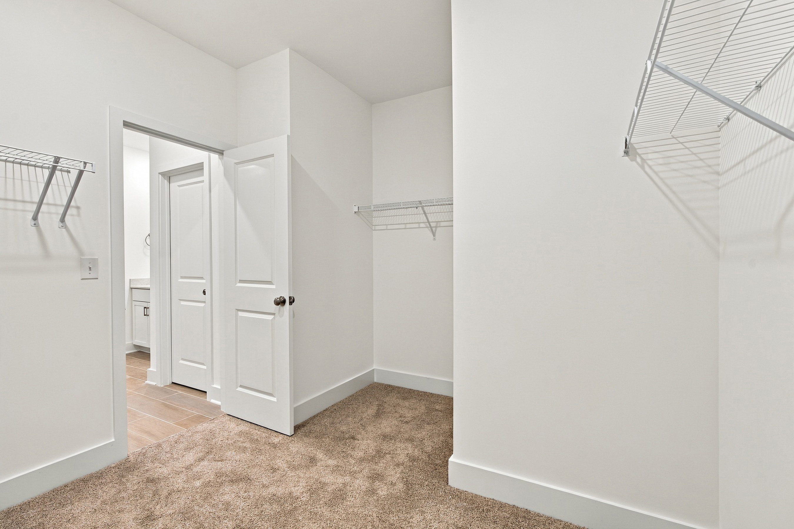 A hallway with white doors.