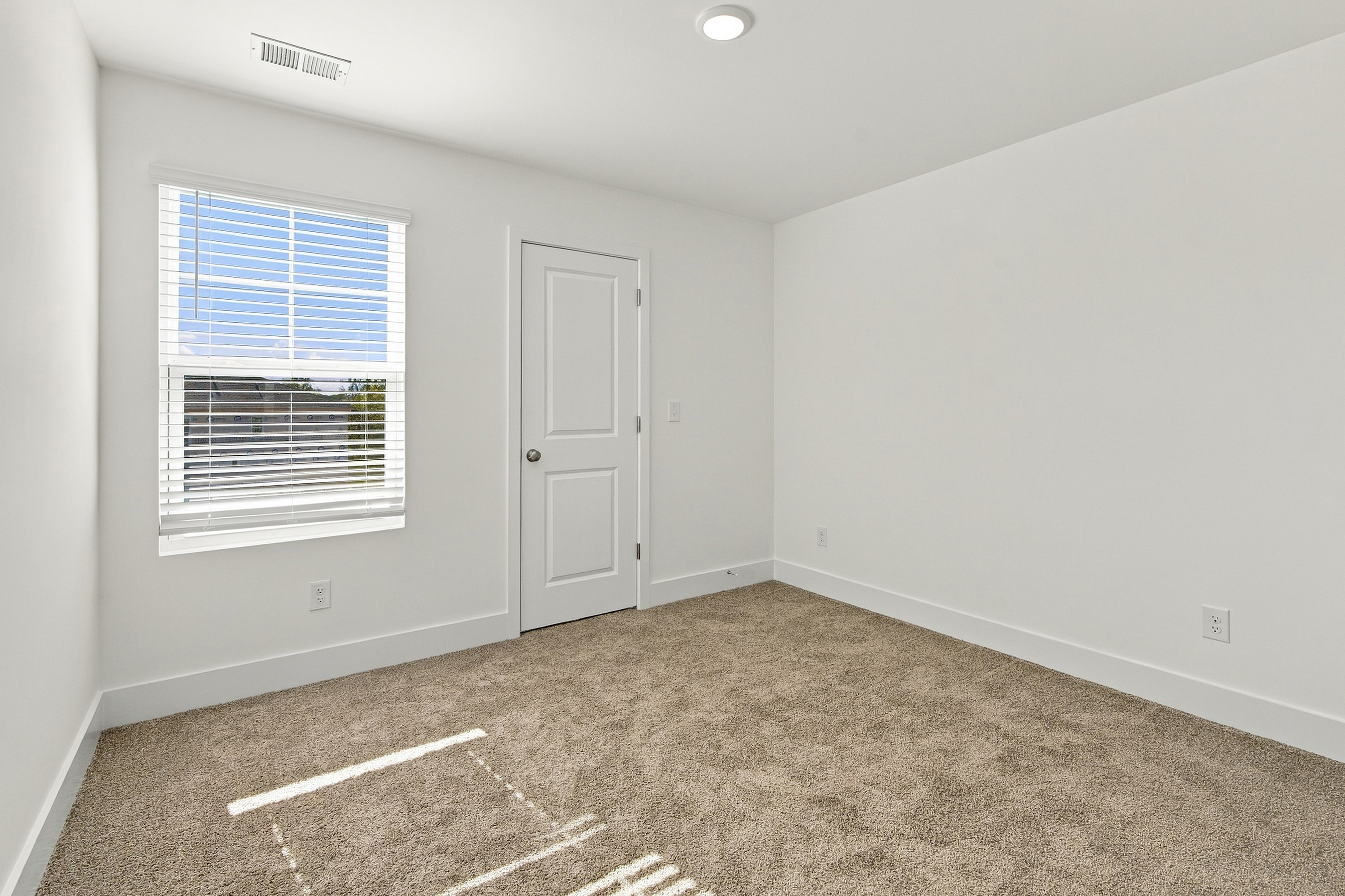 A room with a door and a window.