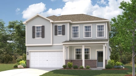 A white house with a lawn and trees in the front.