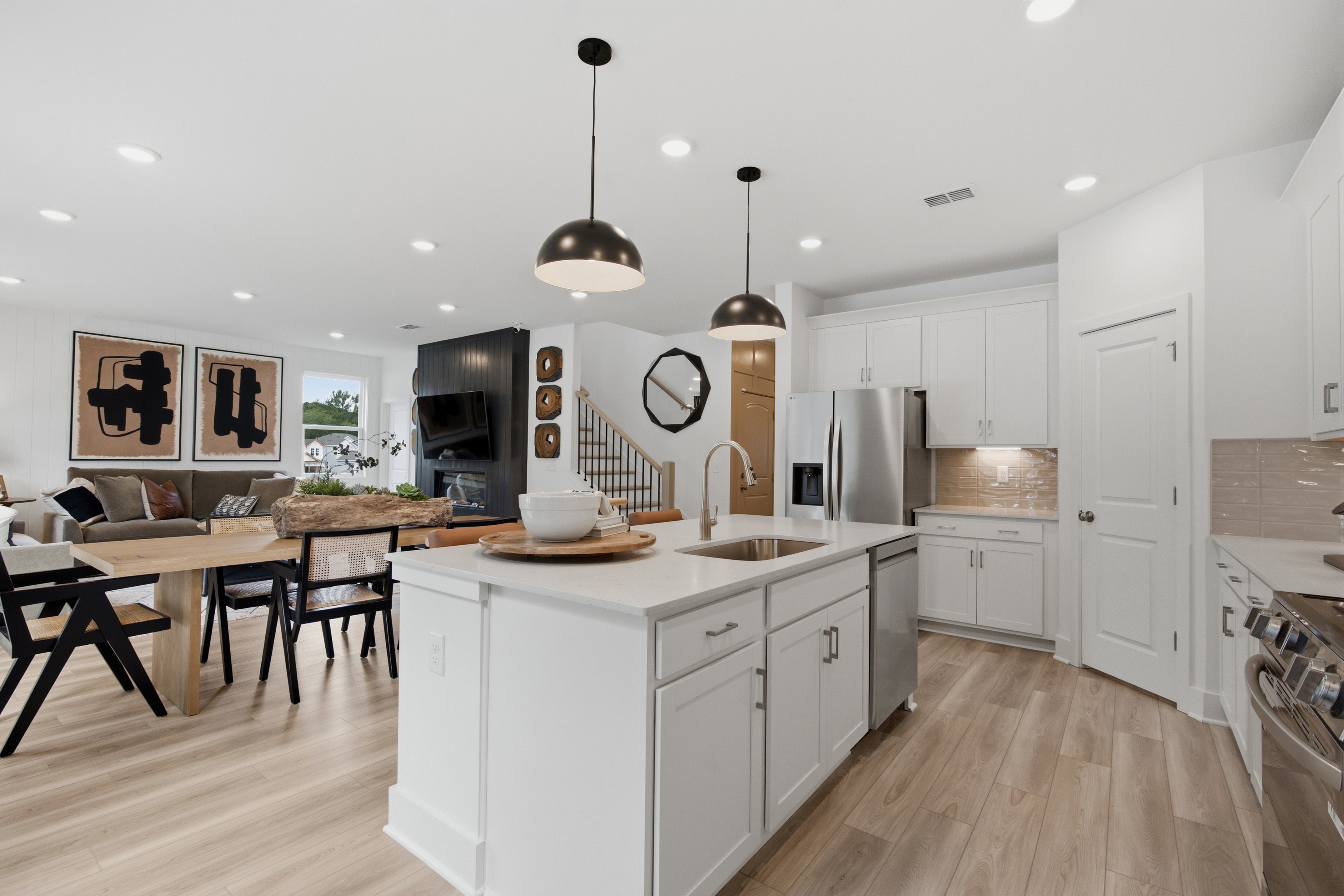 A kitchen with a dining table and a chandelier.
