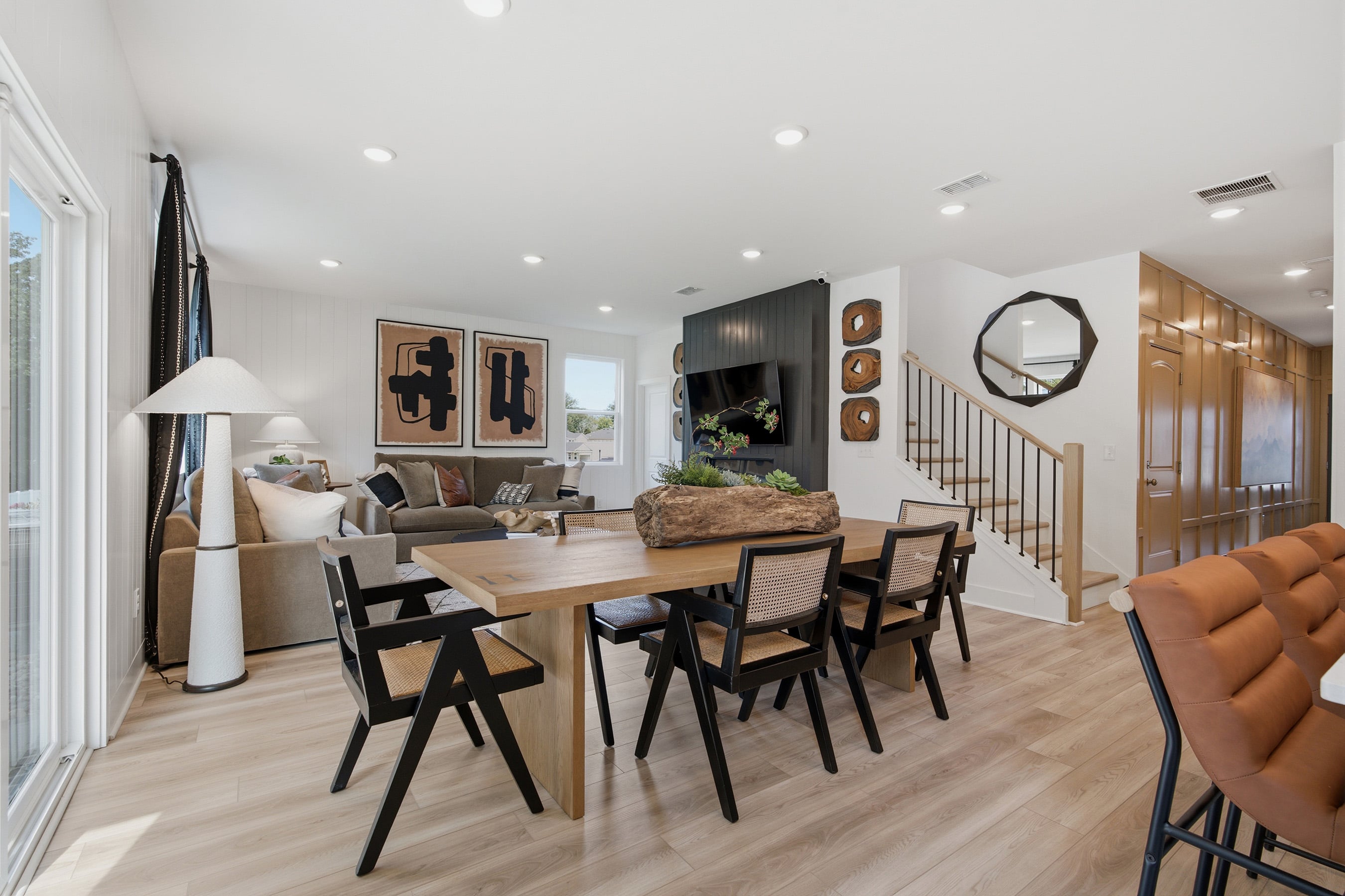 A dining room with a wood floor.