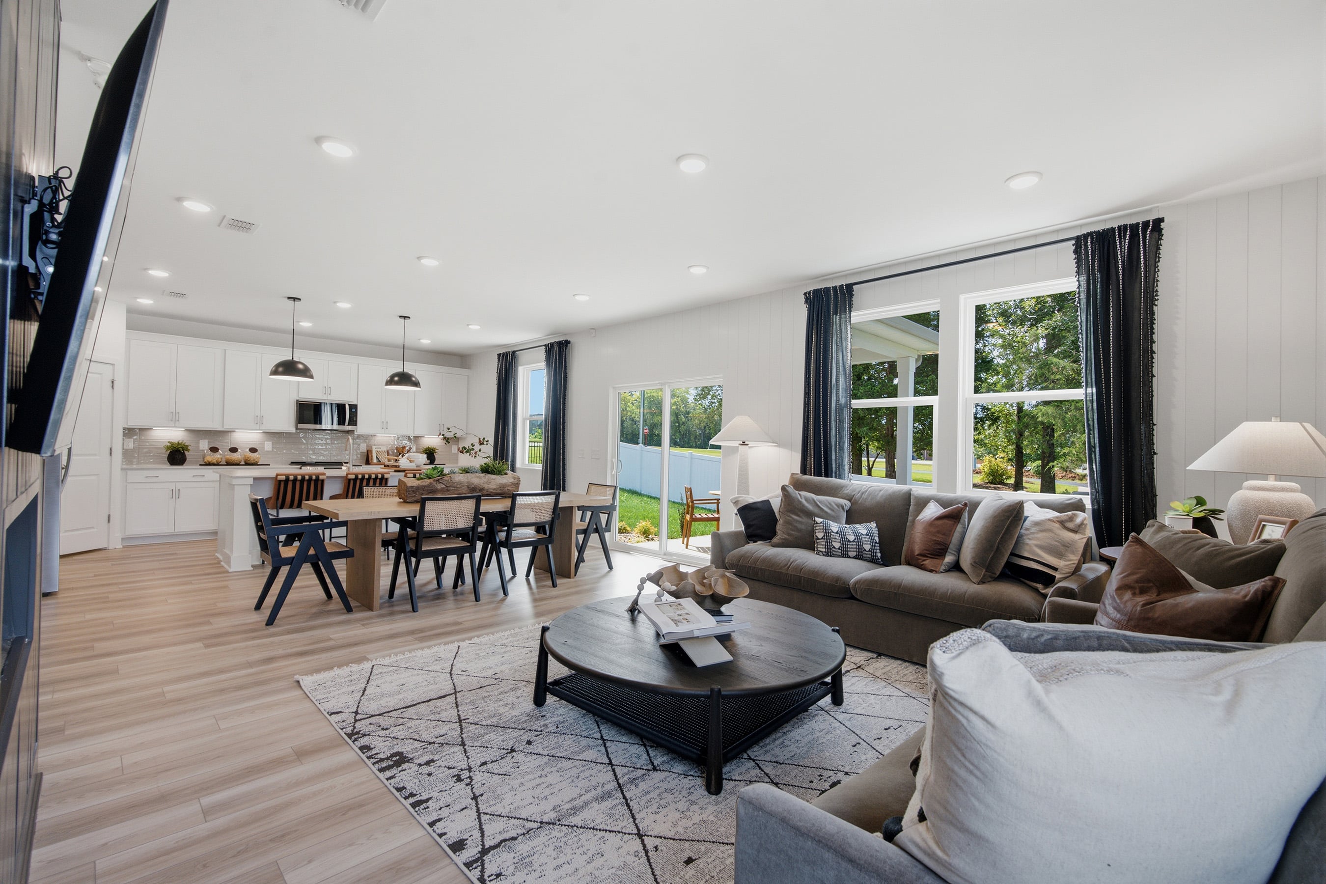 A living room with a large dining table and couches.