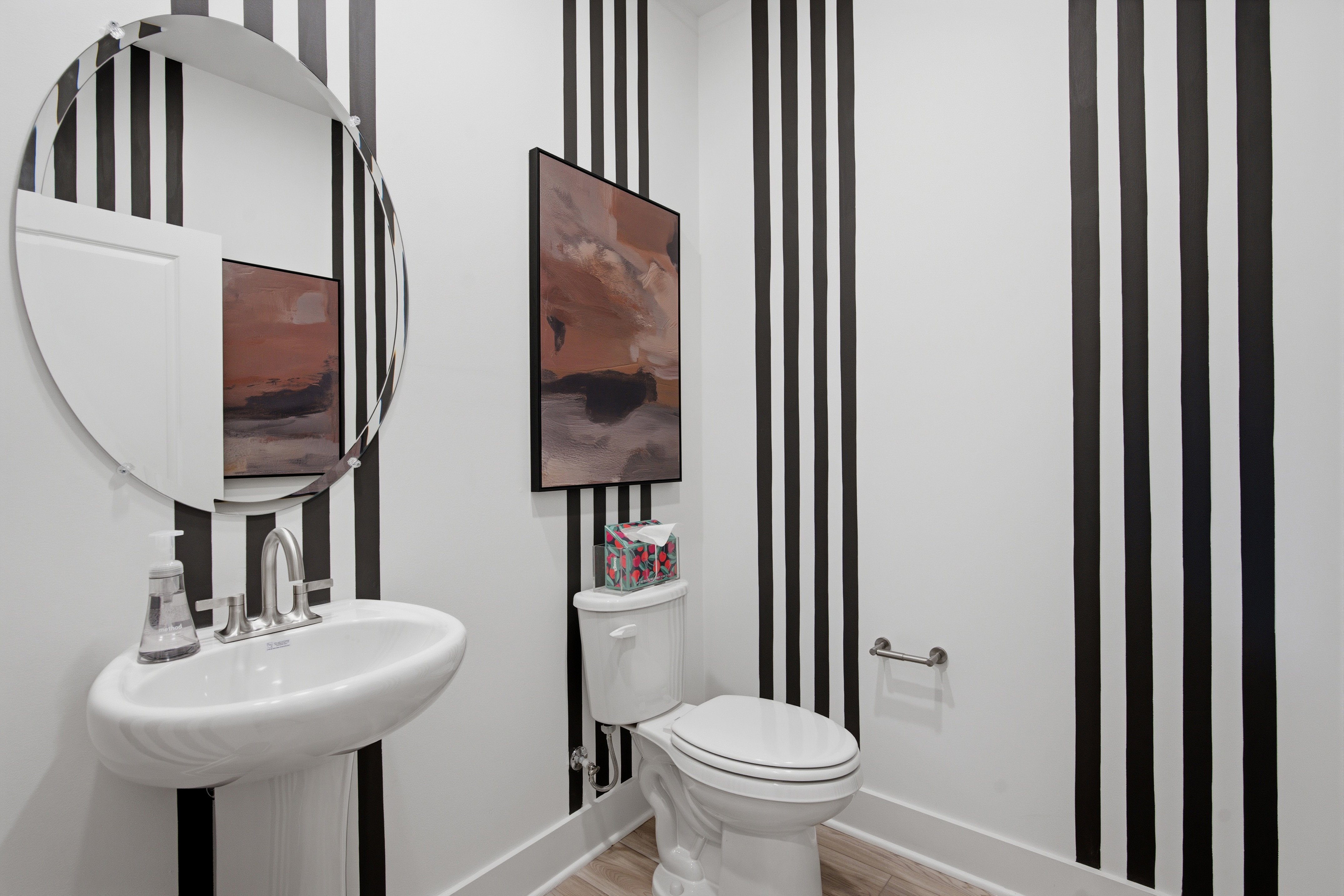 A bathroom with a mirror and a sink.