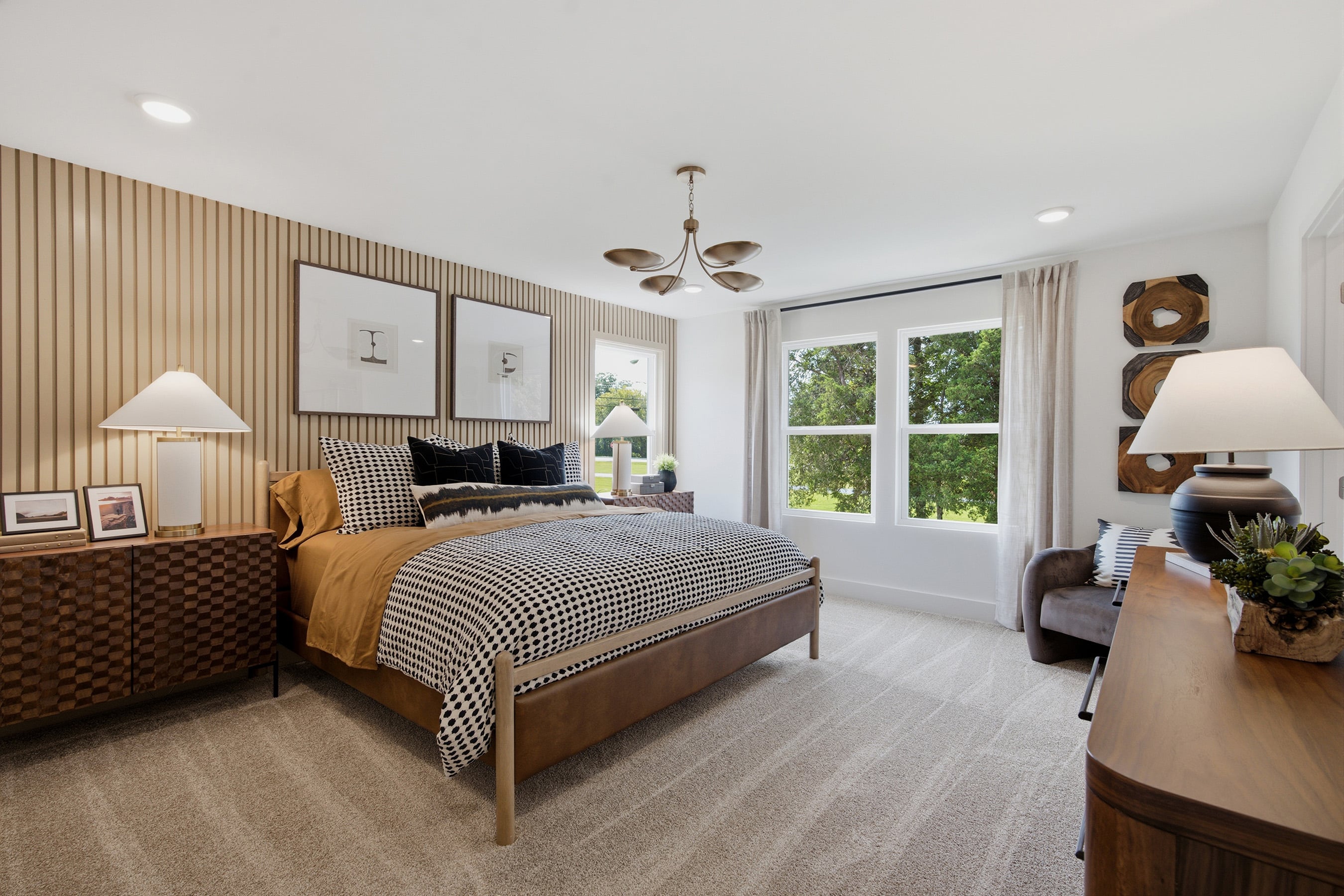 A bedroom with a bed and lamps.