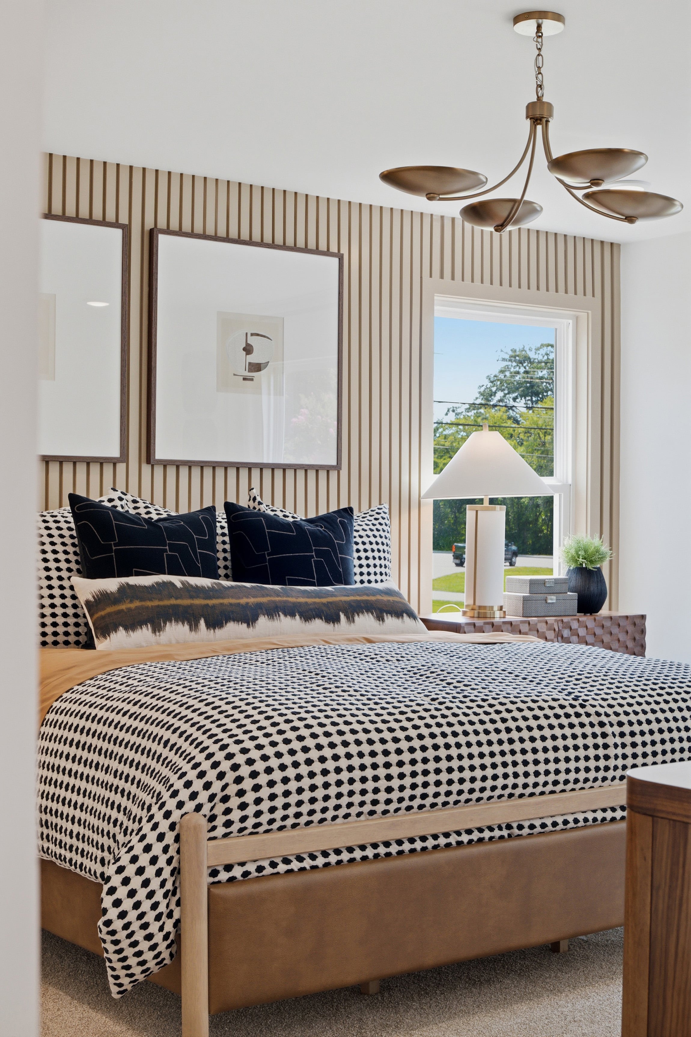 A bed with a mirror above it.