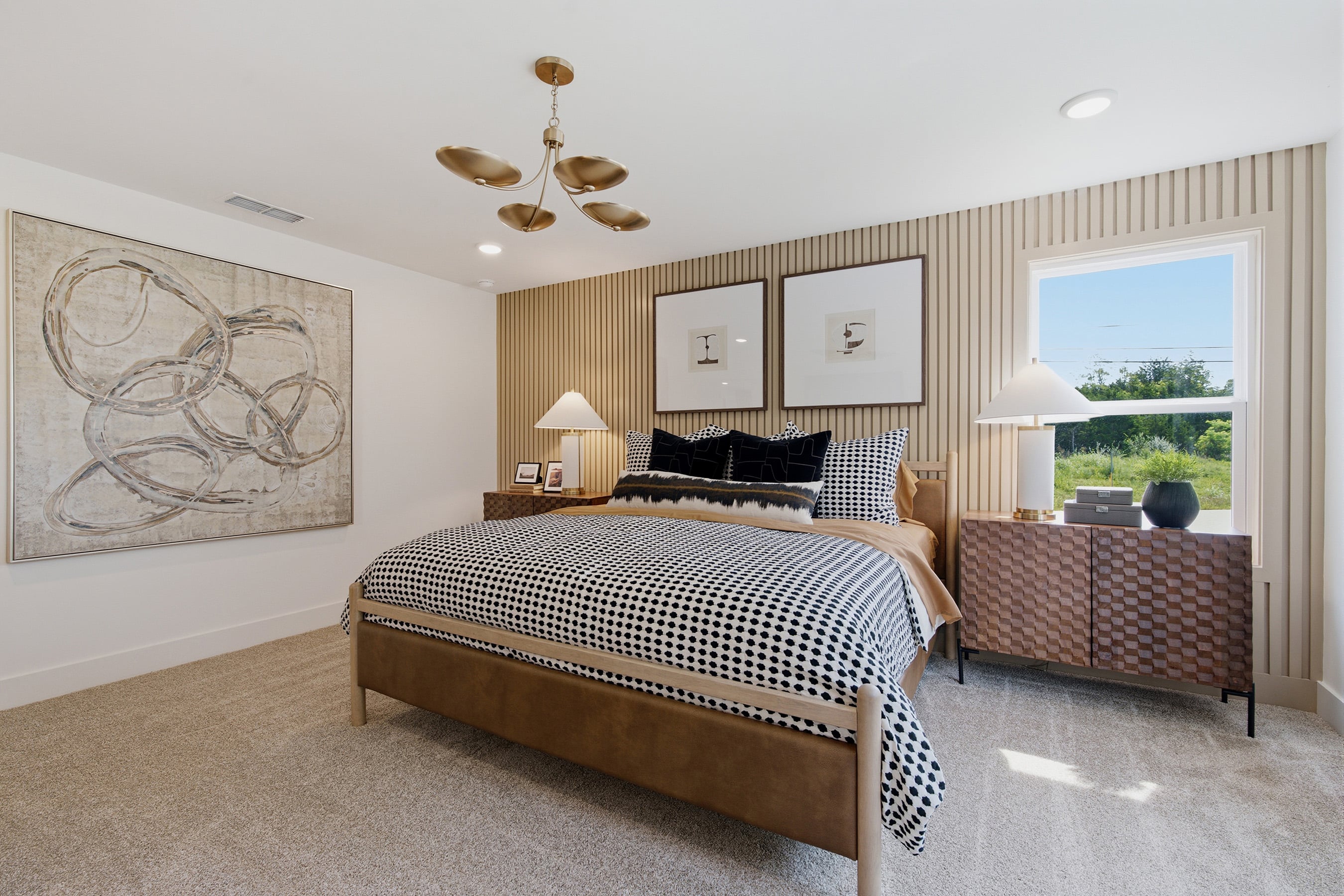 A bedroom with a bed and a lamp.