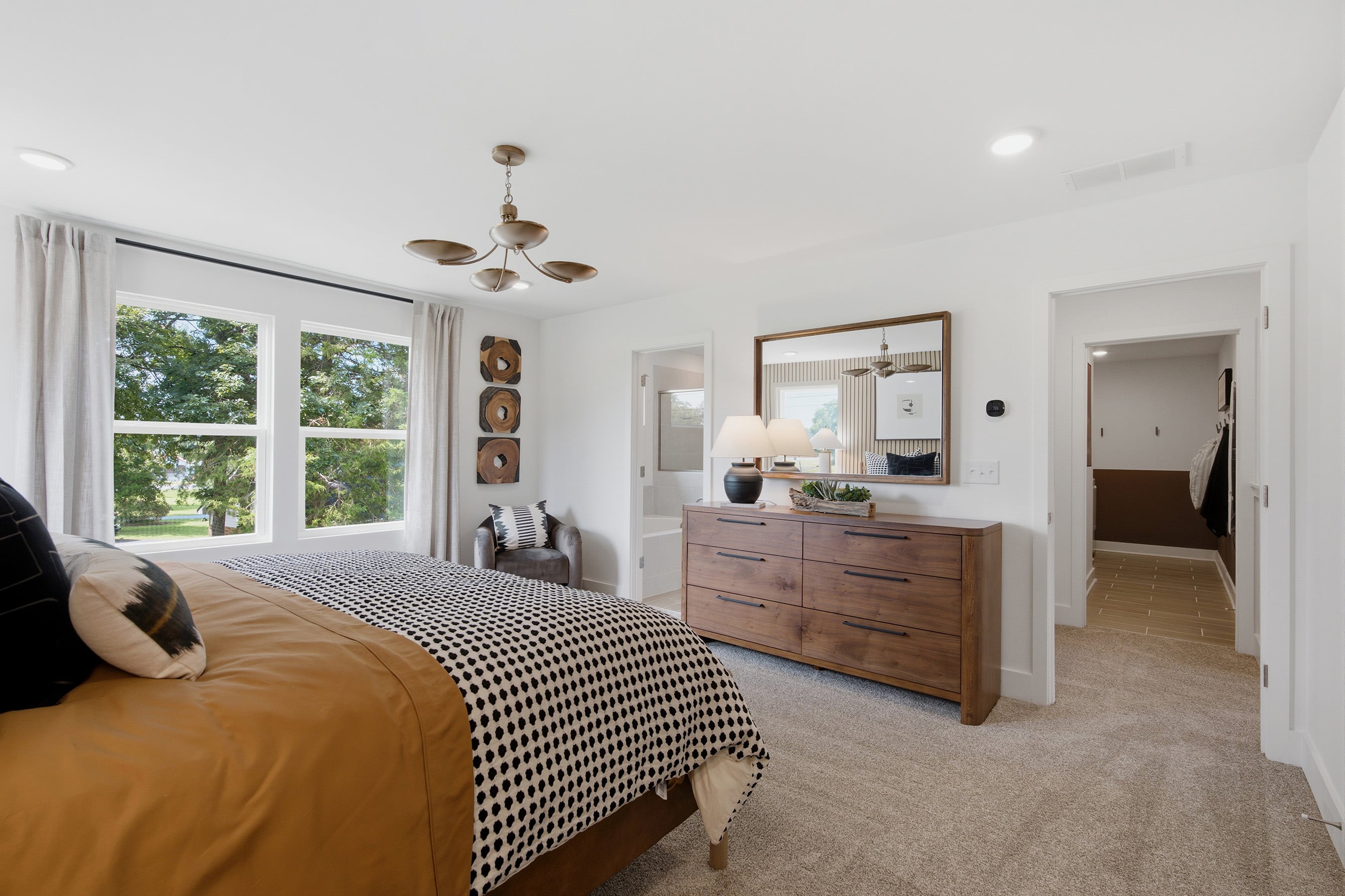 A bedroom with a bed and a dresser.