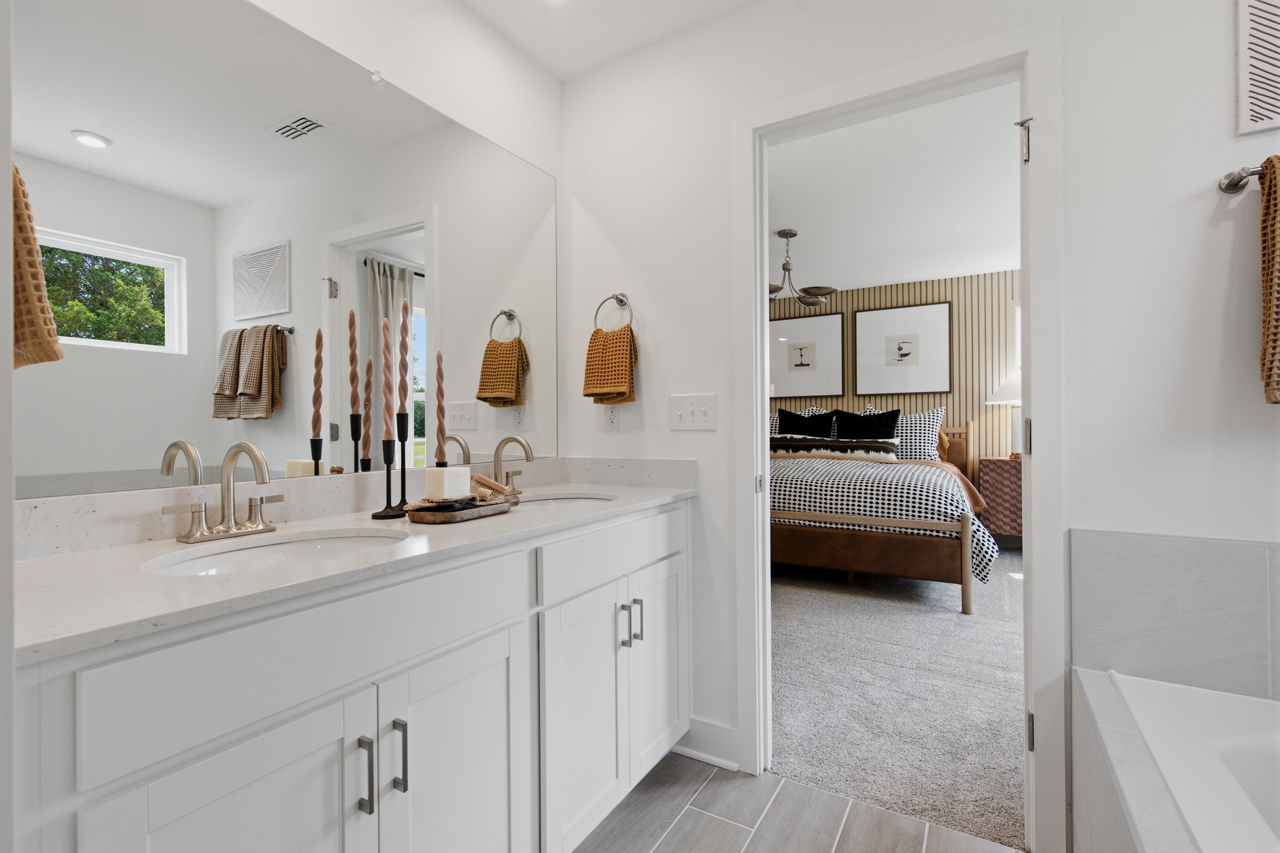 A bathroom with a bed and sink.
