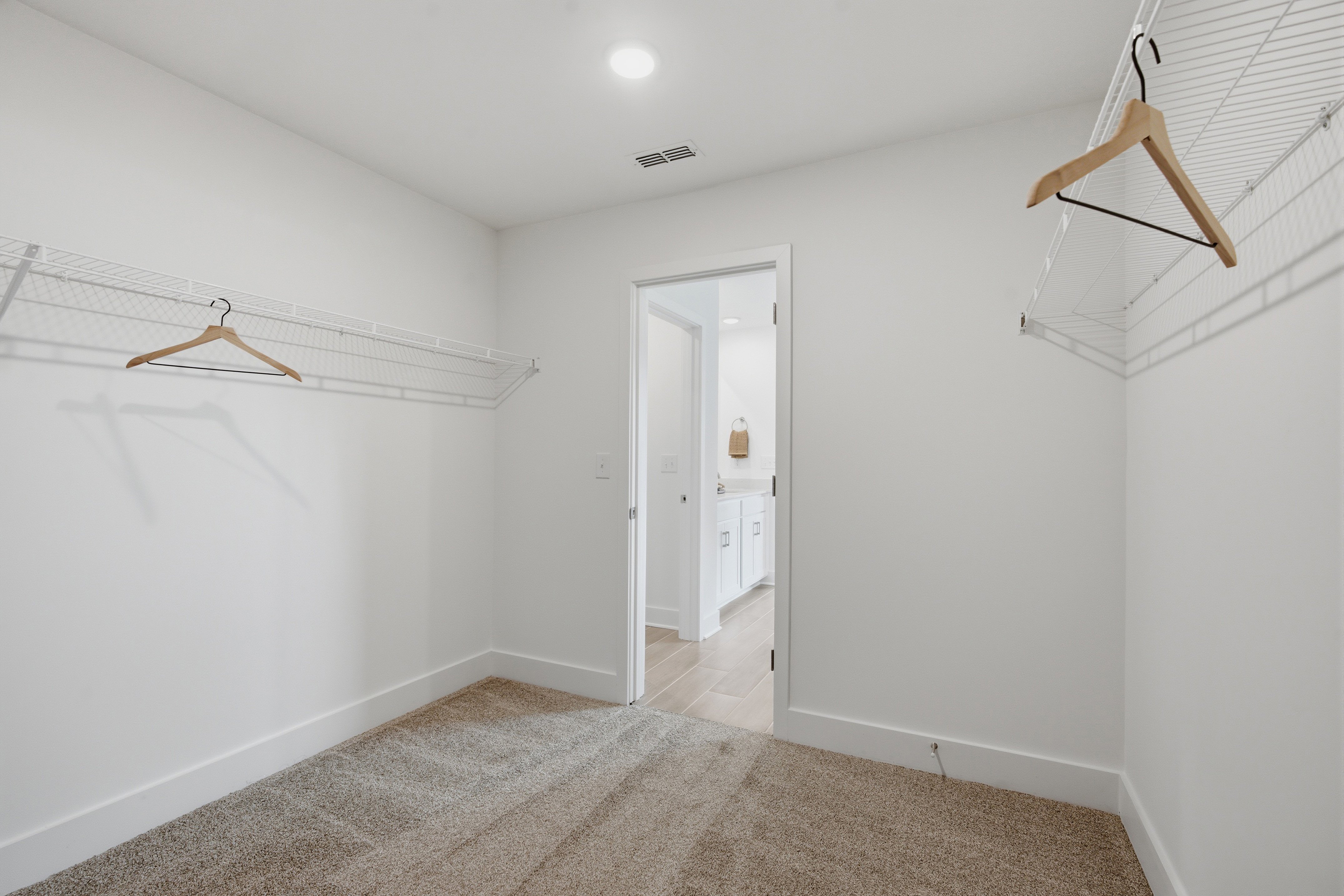 A hallway with white walls.