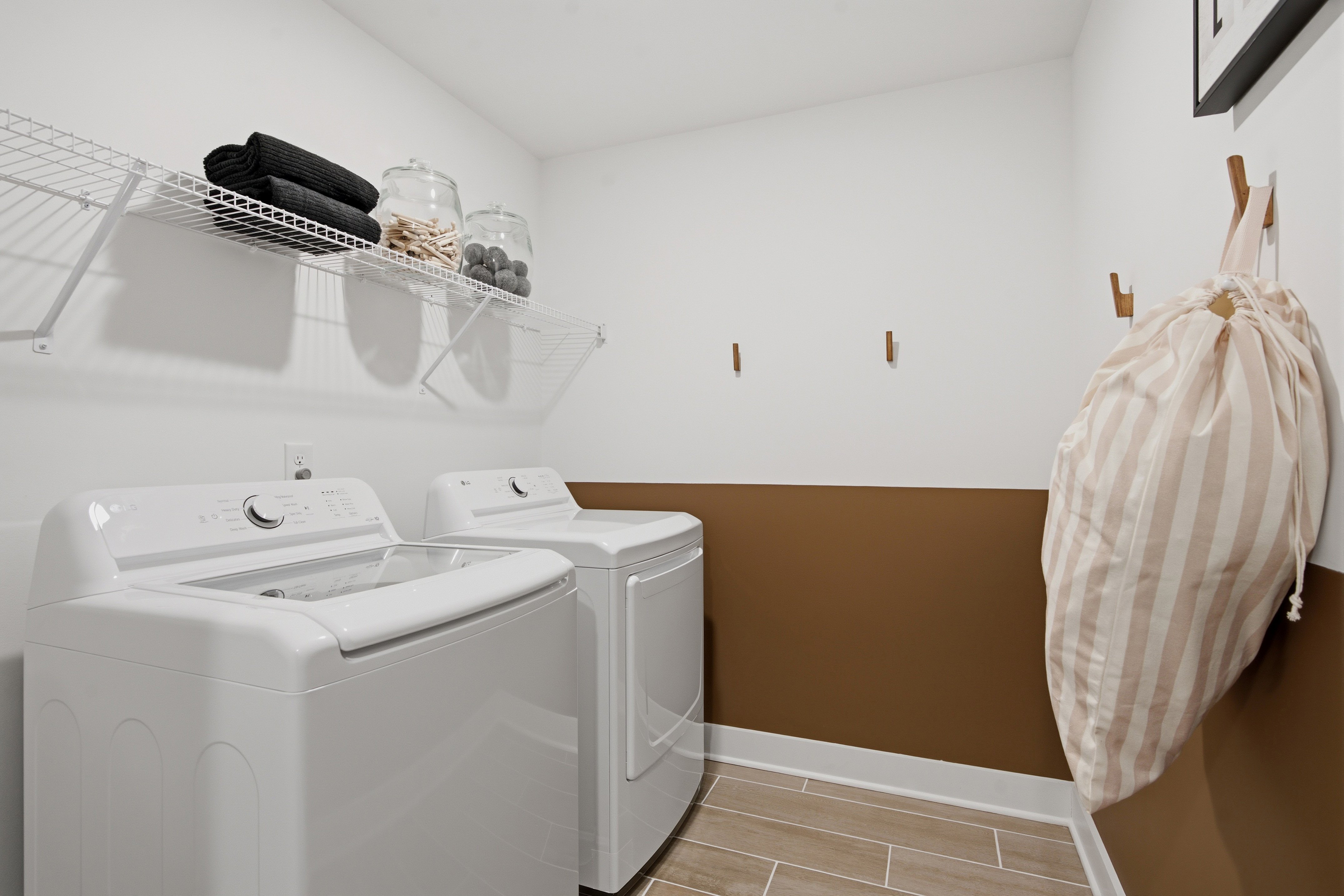 A laundry room with a washing machine.