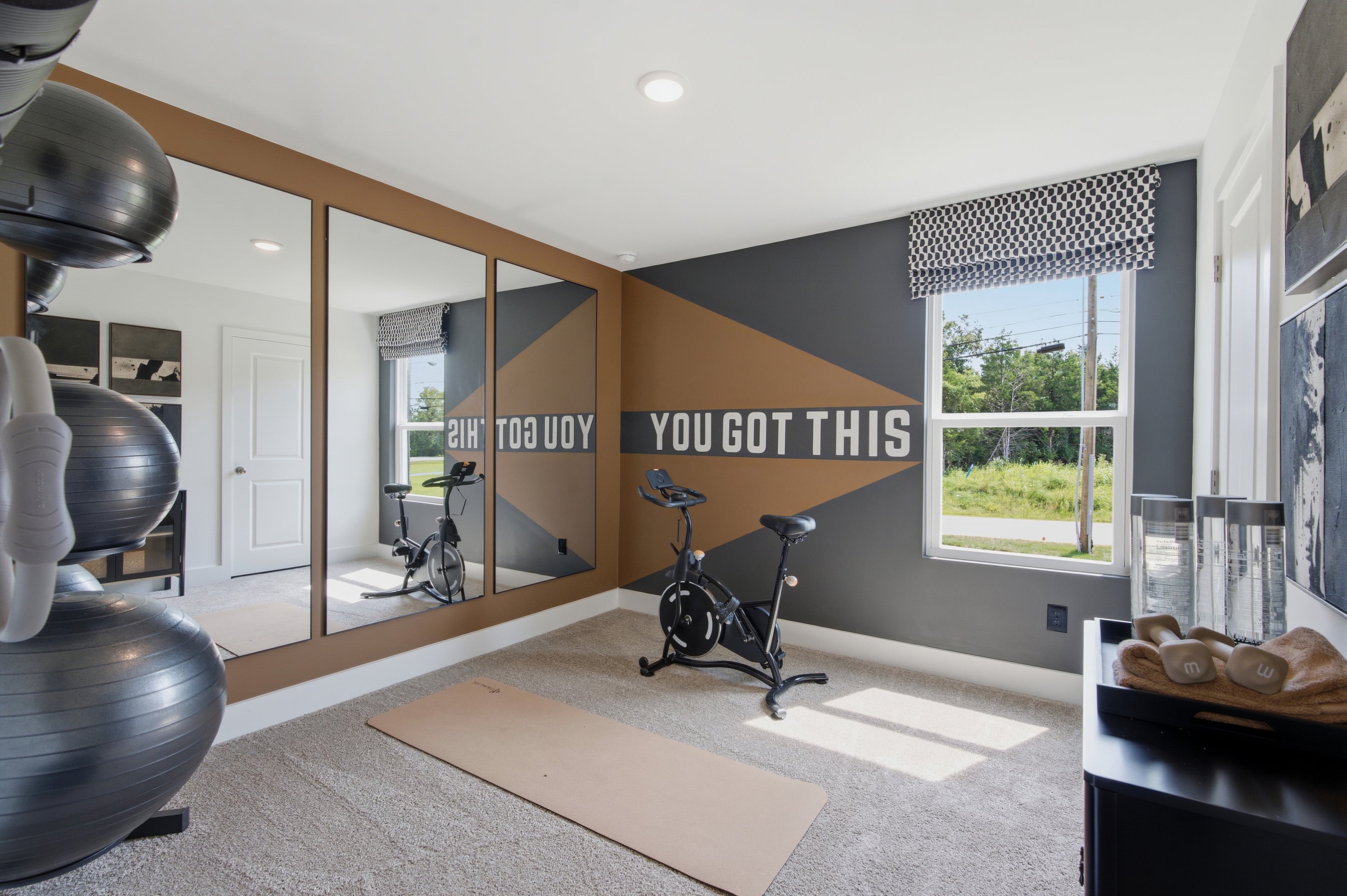 A room with a bike and a window.