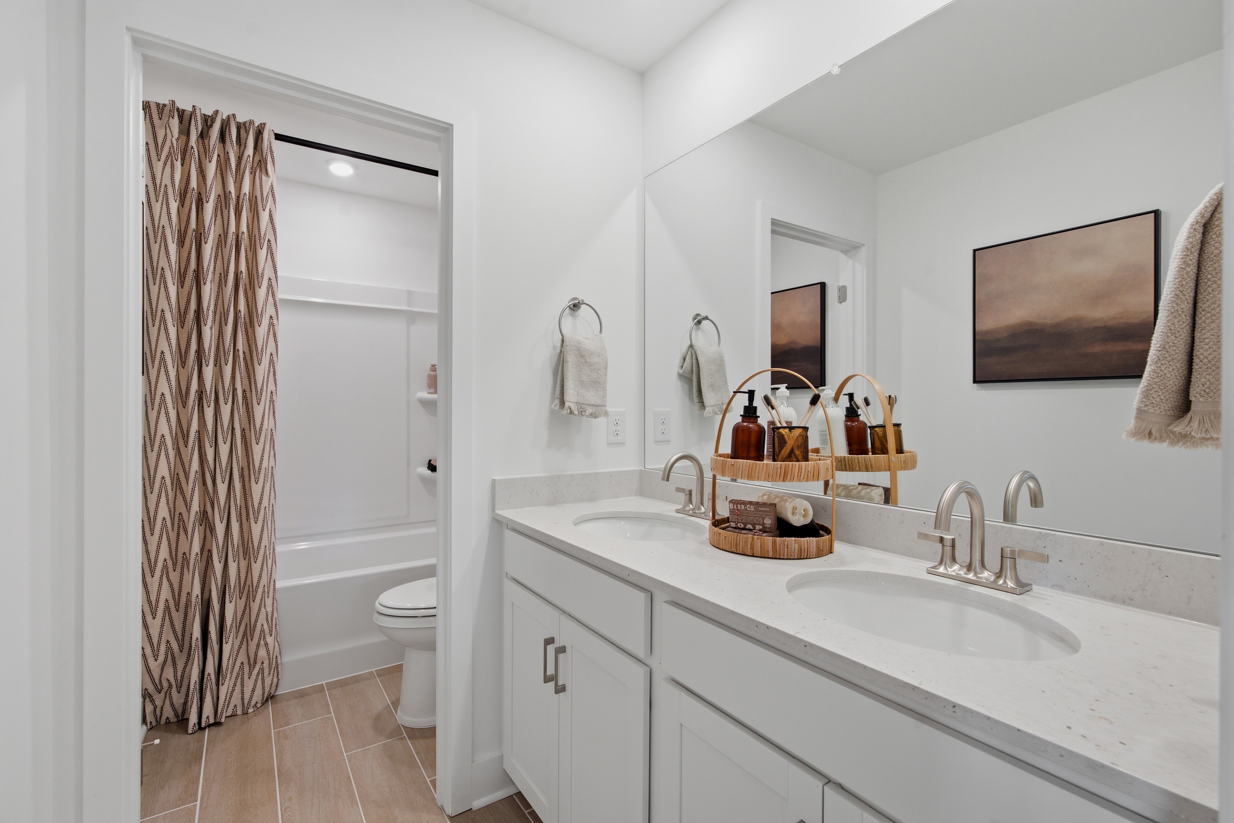 A bathroom with a sink toilet and shower.