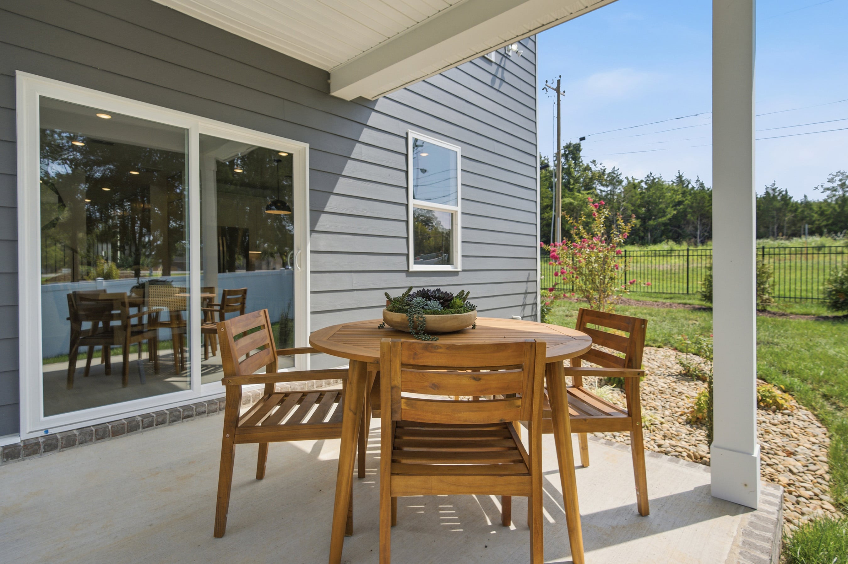 A table and chairs on a deck.