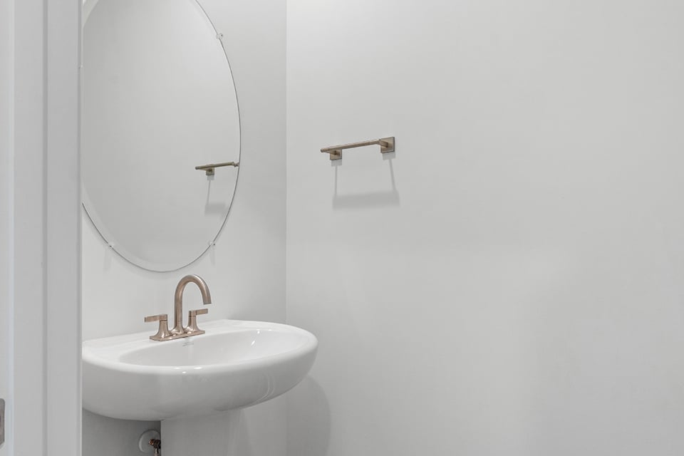 A bathroom with a mirror and sink.