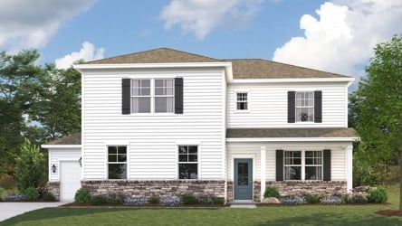 A white house with a lawn.