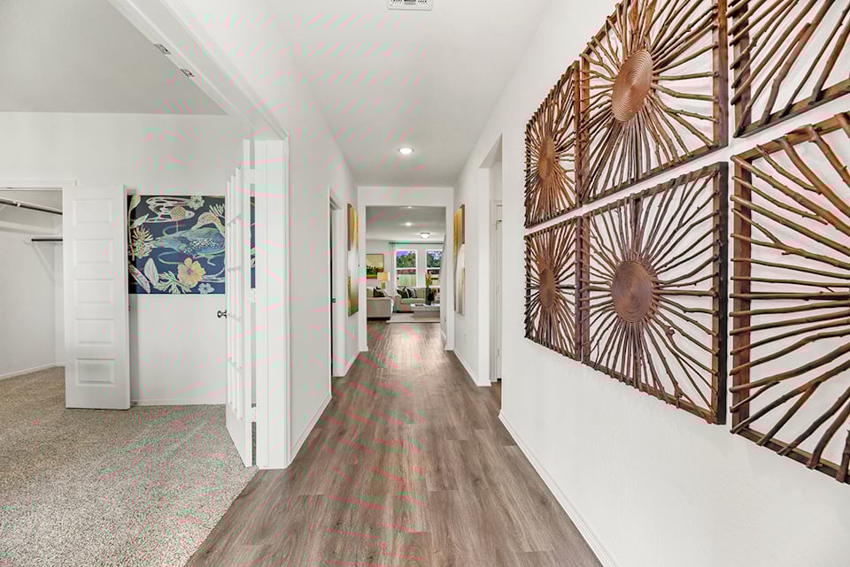 A hallway with a wood floor.