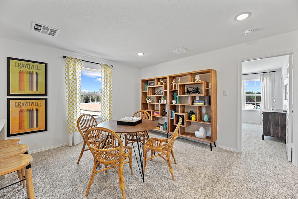 A room with a table and chairs.