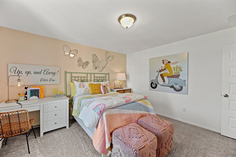 A bedroom with a bed and a chair.