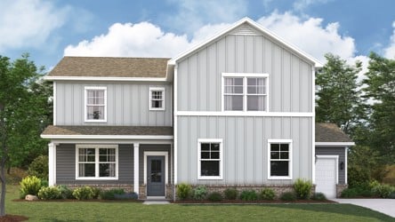 A white house with a lawn in front of it.