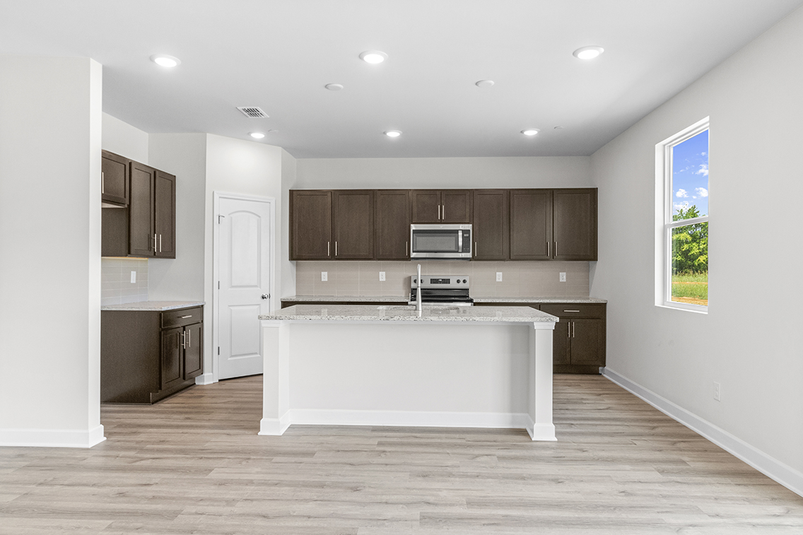 A kitchen with a white counter top.