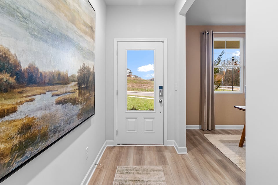 A room with a large painting on the wall.