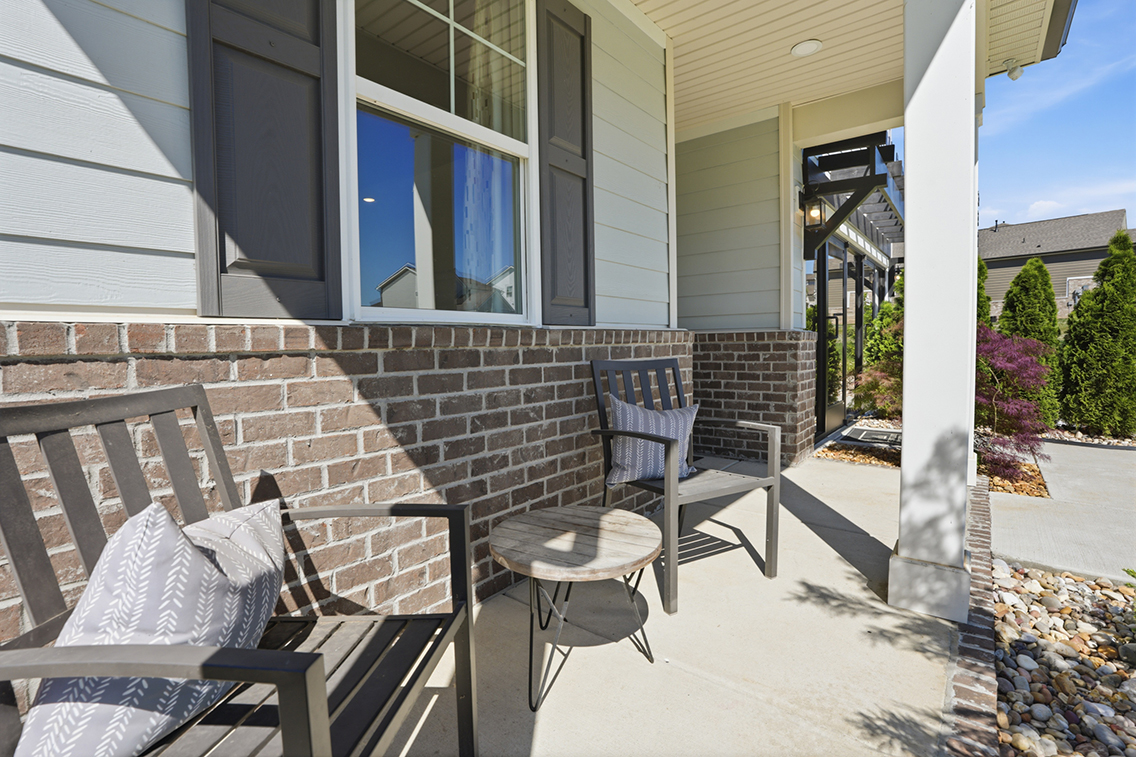 A patio with chairs and a table.
